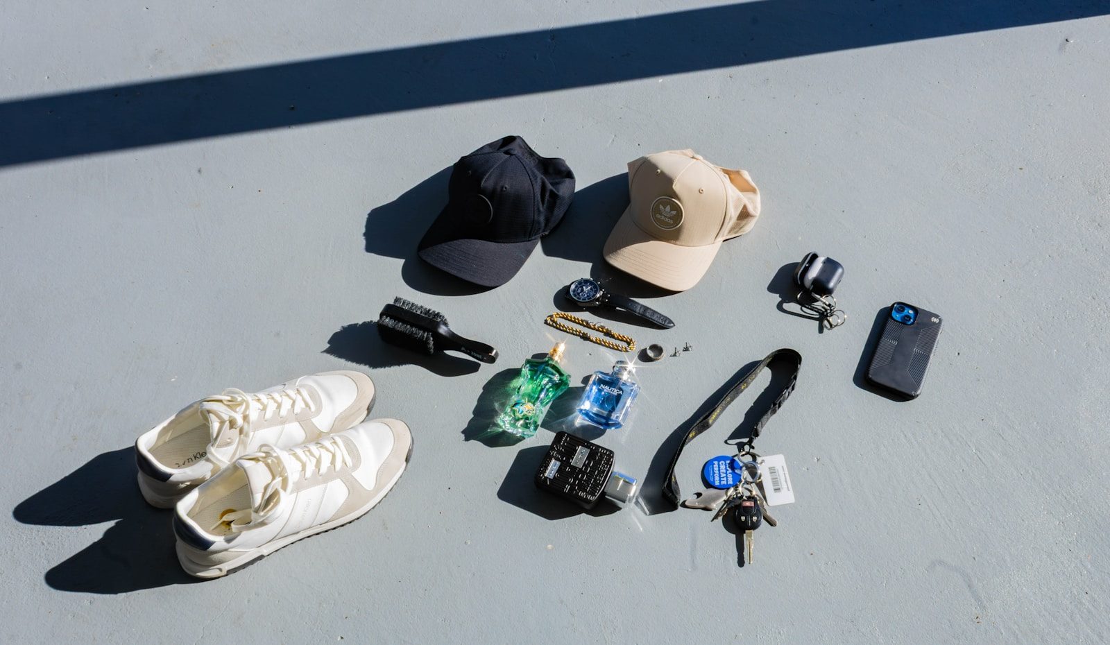 Collection of items including shoes, hats, keys, and phone.